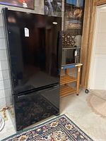 Front exterior view of black Whirlpool Gold refrigerator
