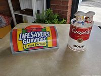 Ceramic Campbell Soup can container and LifeSavers Gummies box on table