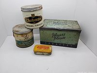 Full view of all four tobacco tins including Player's Please store display tin, Clubman, Macdonald, and Erimore tins.