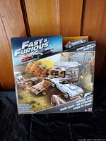 Front view of unopened Fast & Furious Runaway Heist Stunt Action Set box with featured car and stunt elements.