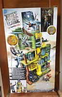 Front of the box showing the full Justice League playset approximately 4 feet tall with multiple characters and levels.