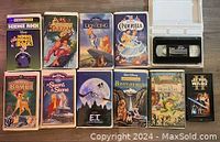Front view of 11 VHS tapes including Disney classics and others such as E.T. and Star Wars.