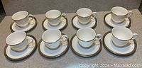 Full set of 8 Lenox Landmark Platinum teacups and saucers arranged in two rows.