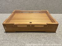 Single wooden sushi serving tray, natural wood slatted base and rectangular raised edges for serving sushi.