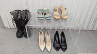 Overview of all pairs: UGGS black winter boots, Zara light blue suede slide heels, Zara beige gold platform heels, black leather peep toe heels, and black classic heels