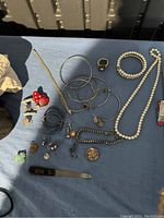 Overview of various jewelry items spread on a blue surface