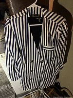 Front view of the women's striped double breasted jacket on a hanger.