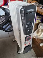 Front and side view of white oil-filled radiator heater by Ritetemp showing control panel with temperature dial, power switch, and timer dial.