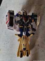 Front view of the space-themed robot toy figure showing detailed colored accents and spaceship part.