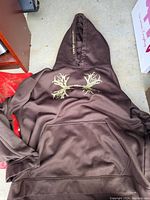 Brown Under Armour pullover hoodie with logo stylized with antlers on chest visible