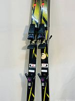 Close-up of the skis showing bindings and color design in black, yellow, and red with Extreme branding.