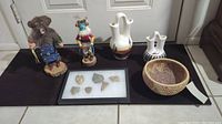 Overview photo showing entire lot: two Kachina dolls, two vases, woven basket, framed arrowheads