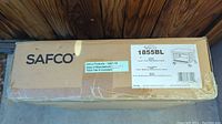 Box label showing Safco brand and model 1855BL with product details including color black and product type under desk machine stand.