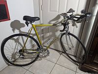 Side view of the vintage yellow Raleigh RT500 road race/triathlon bike showing frame, saddle, wheels and handlebars
