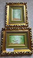 Two framed paintings together, both in ornate gold frames with green velvet insets, showing forest and church subjects