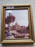 Photo of framed BC Legislative Building photo with gold-colored frame and visible surrounding details.