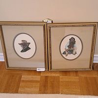 Photo of two framed paintings side by side, showing their scale and framing.