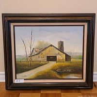 Full view of framed barn yard painting showing the rustic barn, silo, and landscape with signatory "Y. Simon".