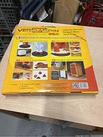 Photo showing the Versaspin 360 turntable boxed product, highlighting features and uses on packaging.