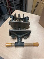 Top angle photo of the Richards-Wilcox woodworking vise showing cylindrical wooden handles and cast metal body.