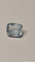 Photo showing the 2.35 carat natural blue aquamarine gemstone cushion cut shape and light blue color.