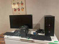 View of entire lot on table showing ViewSonic monitor, HP EliteDesk tower, two keyboards, mouse and Legacy speakers with cables.