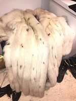 Front and back view of coat draped over a chair showing full length