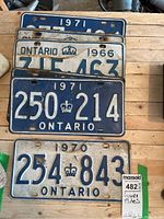 Four Ontario license plates stacked, showing two from 1971, one from 1966, and one from 1970
