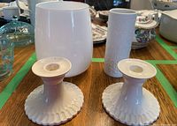 Photo showing two white Copeland Spode ceramic candlesticks, white Rosenthal vase and a textured white glass vase on wooden surface