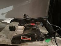 Craftsman electric hand planer showing overall tool with handle, depth adjustment knob, and power cord.