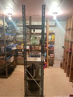 Full view of metal shelving unit with contents for size reference only, contents not included.
