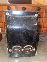 Front view showing black metal transformer with electrical socket outlets marked B2K and SEC 115V.