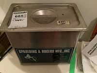 Front view of ultrasonic cleaner with Spaulding & Rogers branding, timer dial and power light.