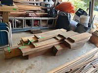 Photos show a collection of assorted wood pieces stacked in a garage space. Green tape labels identify wood types: walnut, oak, and pine. Pieces vary in size and thickness with rough cut edges visible.