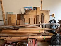 Overall pile of assorted wood boards and strips in garage