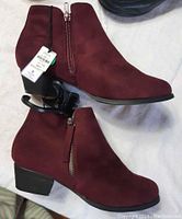 Side view of the burgundy Ardene ankle boots showing the zipper and block heel.