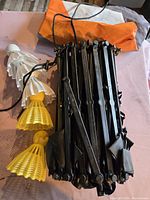 Folded circular net with black frame, five birdie targets in white and yellow on pink surface