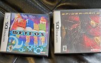 Front view of two Nintendo DS game cases, Spider-Man 2 and Meteos, showing cover art.