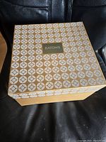 Photo of the vintage Eatons box showing beige and white geometric pattern with Eatons logo in center
