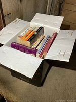 Open box with visible novels packed inside showing condition and quantity