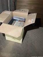 Box filled with various books labelled 'Fiction' on the box flap.