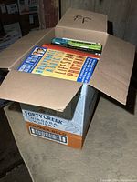 Closed box filled with various books showing top titles like 'Quit Smoking Through Hypnosis' and 'Dealing with Alzheimer's Lifespan Program'.