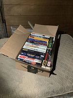 Box full of various Star Wars books with visible titles 'Aftermath Life Debt', 'Thrawn Treason', 'The Last Command', 'Scoundrels', and 'The Truce at Bakura'.