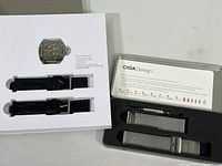 Original presentation tray showing watch head cutout and two extra straps in slots