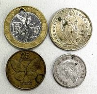 Top view of four coins showing front sides including France 10 francs with hole, Switzerland 1 franc, Philippines 25 sentimos with butterfly, and Canada 10 cents with King George VI.