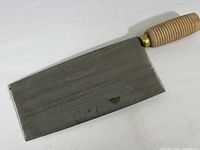 Full view of the steel rectangular blade showing surface wear and slight discoloration.