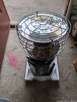 Top-down view of the Dyna-Glo portable propane heater showing the metal guard and reflective heat plate.