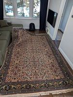 Full view of rug laid out in living room showing pattern and size