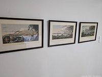 View of all three framed paintings hanging on a wall, presenting waterfront and harbour scenes