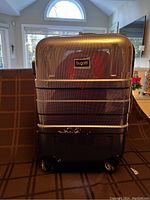 Front view of Bugatti carry-on suitcase with textured black finish and wheels.